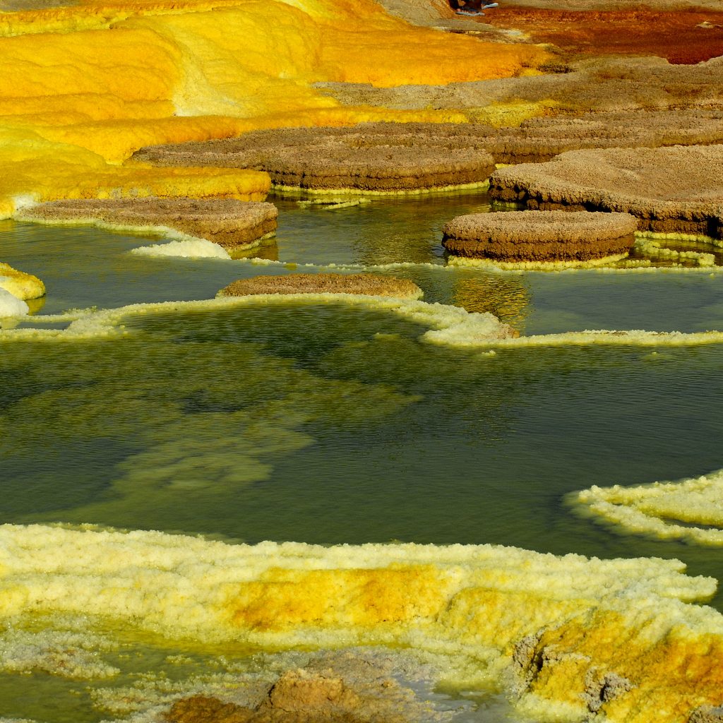 Danakil Depression salt flats and extreme desert landscape Ethiopia Erta Ale volcano lava lake glowing at night Dallol sulfur springs colorful mineral formations Afar salt miners camel caravan in desert Ethiopia Desert camping under stars during Danakil Expedition Travelers on the 5-Day Danakil Expedition exploring volcano landscape