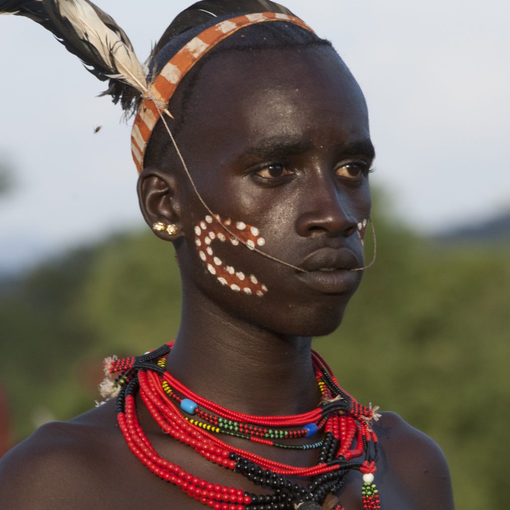 Mursi tribe woman with traditional lip plate in Ethiopia Hamar tribe cultural dance in Southern Ethiopia Scenic landscape of the Omo Valley region Traditional tribal market in Jinka Ethiopia Karo tribe body painting near the Omo River Travelers enjoying the 7-Day Omo Valley Tour in Ethiopia