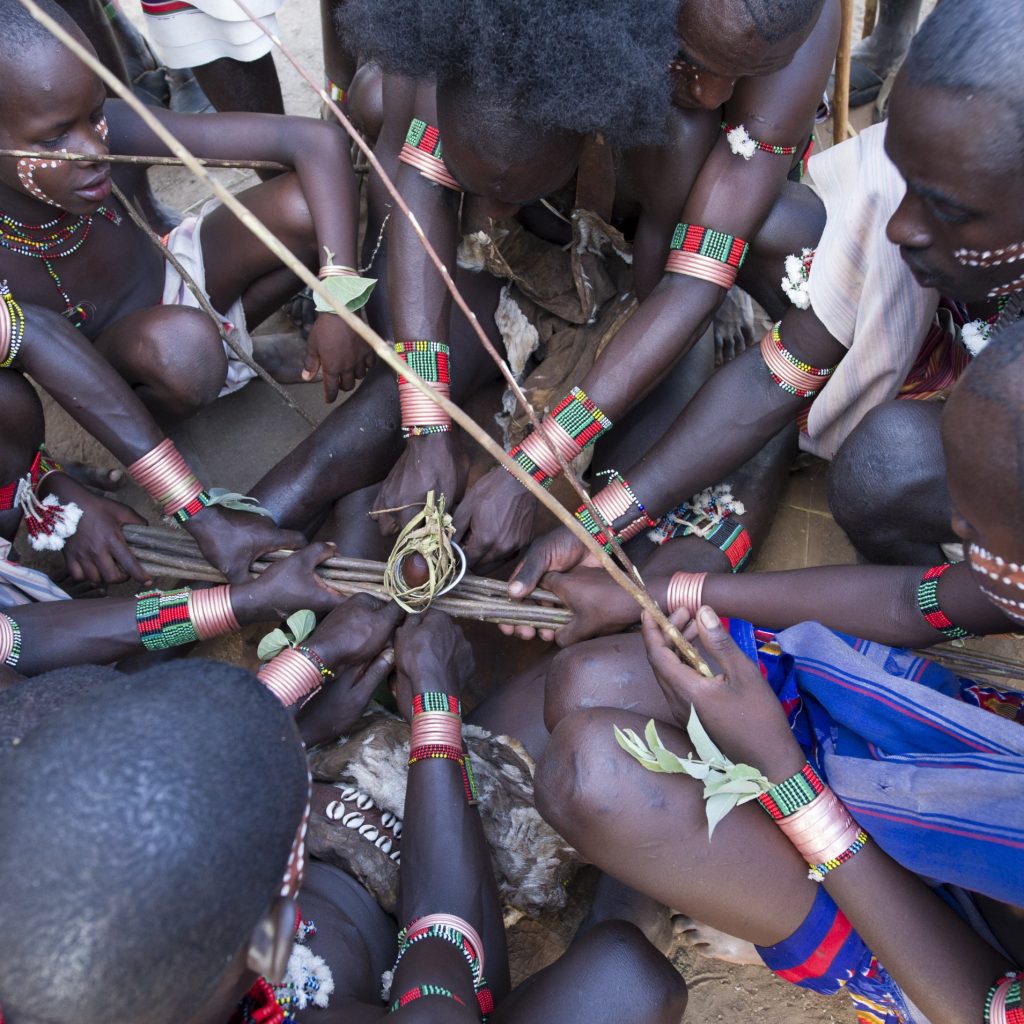 Mursi tribe woman with traditional lip plate in Ethiopia Hamar tribe cultural dance in Southern Ethiopia Scenic landscape in the Omo Valley region Traditional tribal market in Jinka Ethiopia Karo tribe body painting near the Omo River Travelers exploring villages during the 7-Day Omo Valley Tour